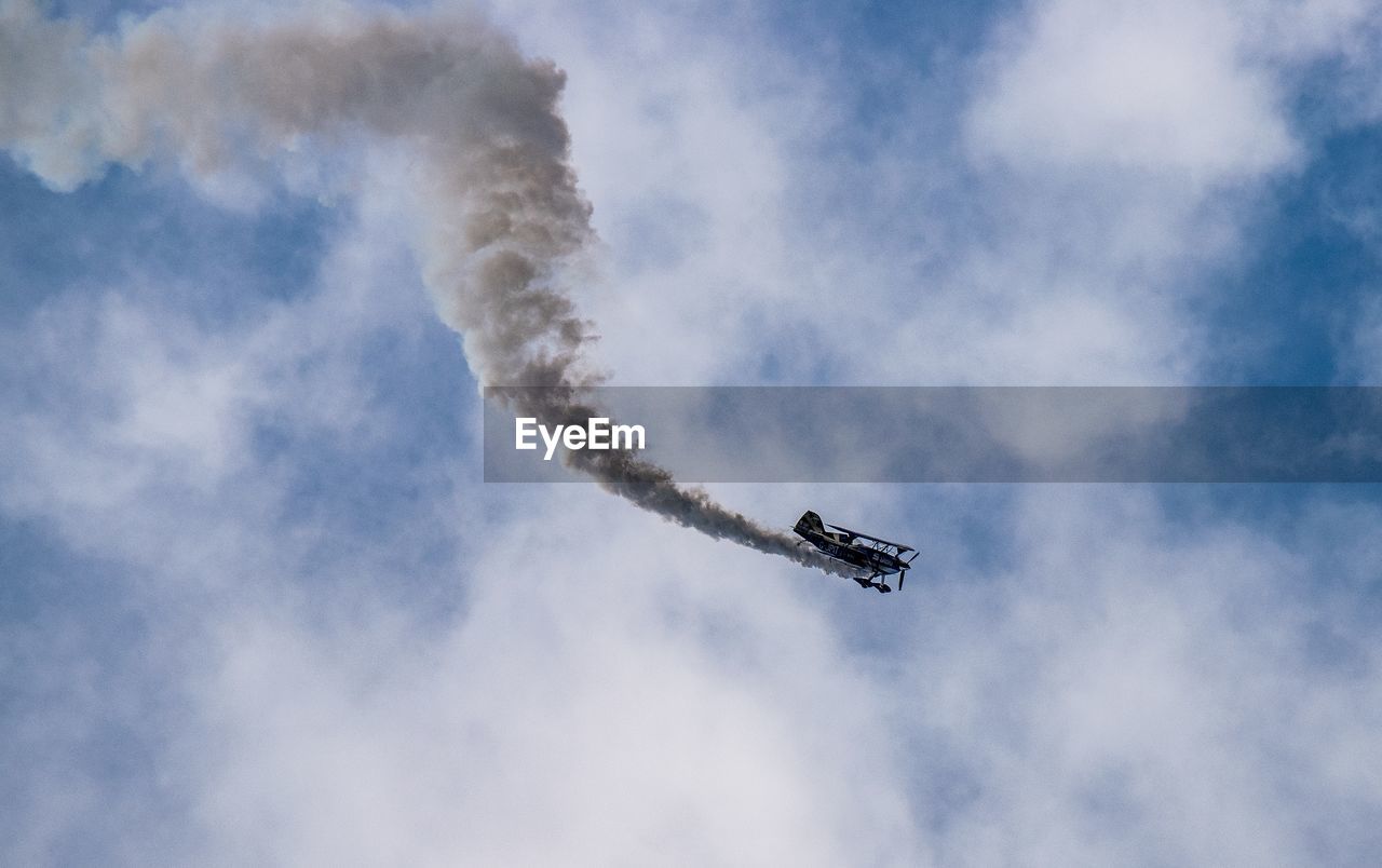 Low angle view of airplane flying in sky