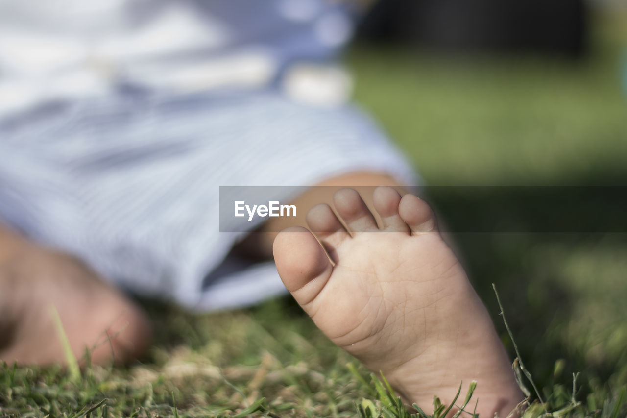 Baby foot sitting in a park