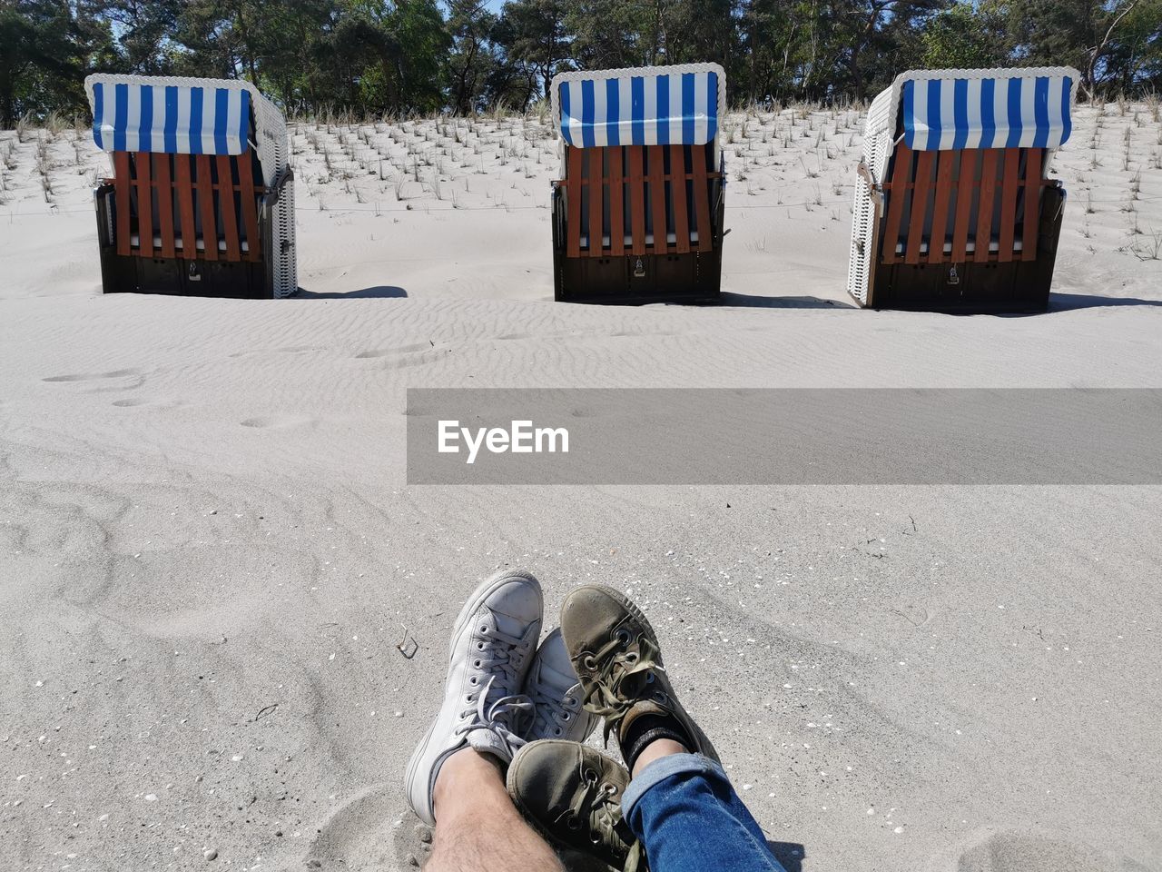 low section, human leg, sand, land, shoe, one person, nature, beach, lifestyles, personal perspective, leisure activity, men, day, relaxation, outdoors, winter, blue, human limb, casual clothing, limb, snow, standing, adult, water, vacation, trip, holiday, footwear