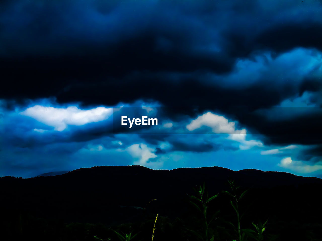 STORM CLOUDS OVER SILHOUETTE MOUNTAIN