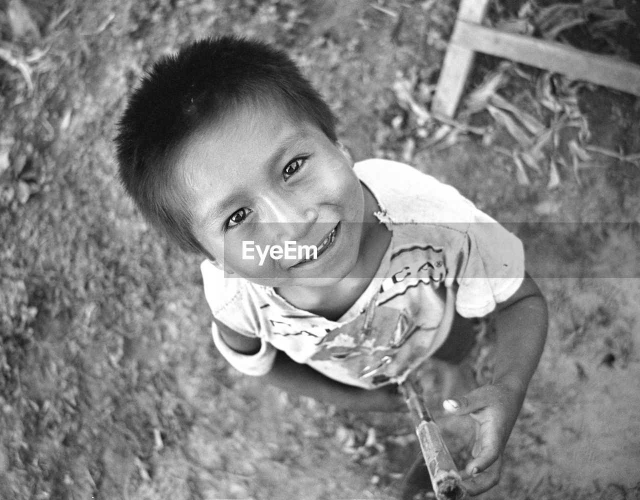 HIGH ANGLE VIEW PORTRAIT OF BOY PLAYING OUTDOORS