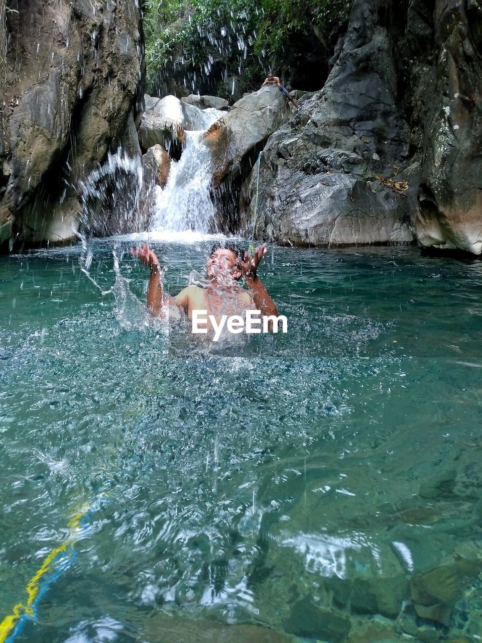 MAN SWIMMING IN RIVER