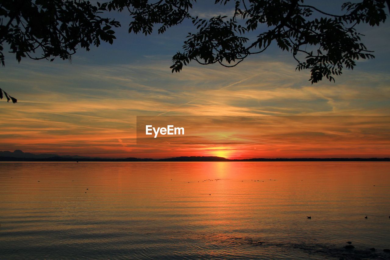 SCENIC VIEW OF SEA AGAINST ORANGE SKY DURING SUNSET