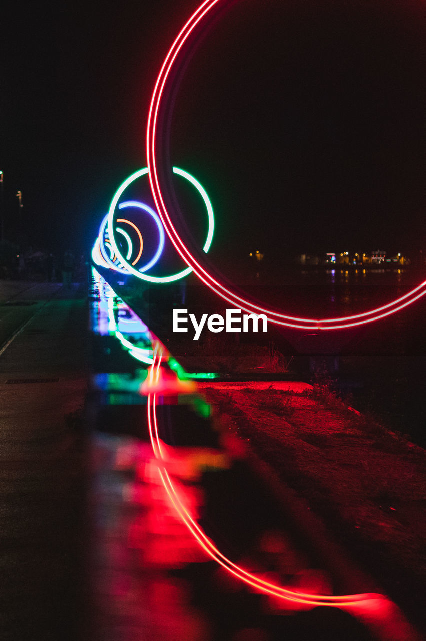 CLOSE-UP OF ILLUMINATED LIGHT TRAILS ON NIGHT