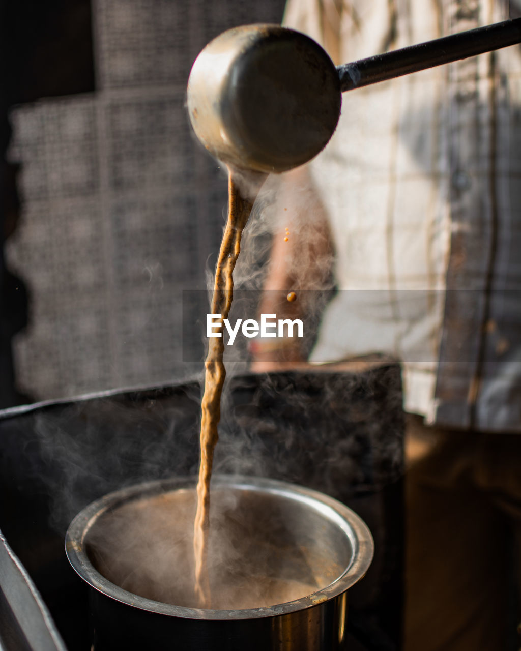 Close-up of tea pouring in vessel 