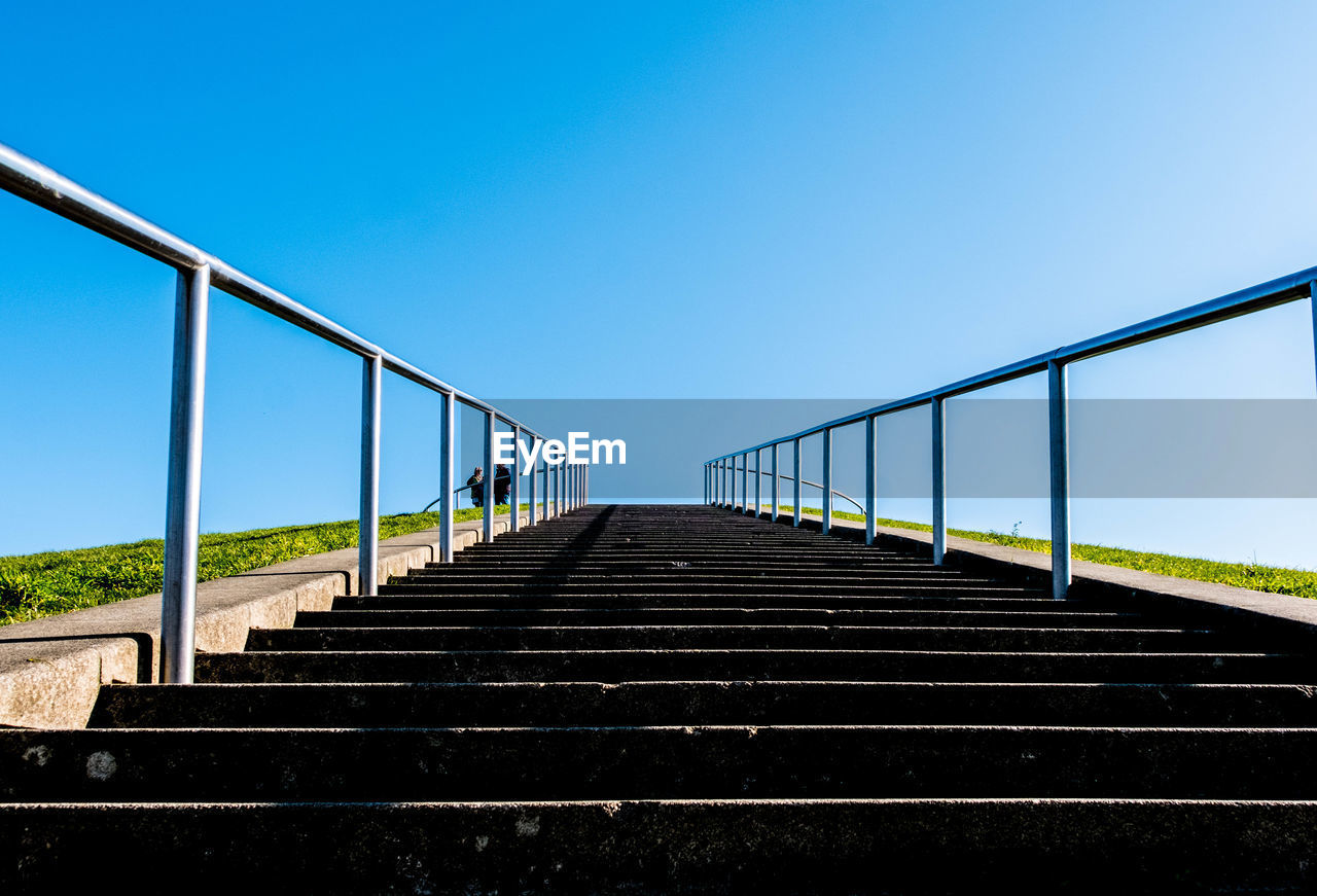 Low angle view of bridge against clear blue sky