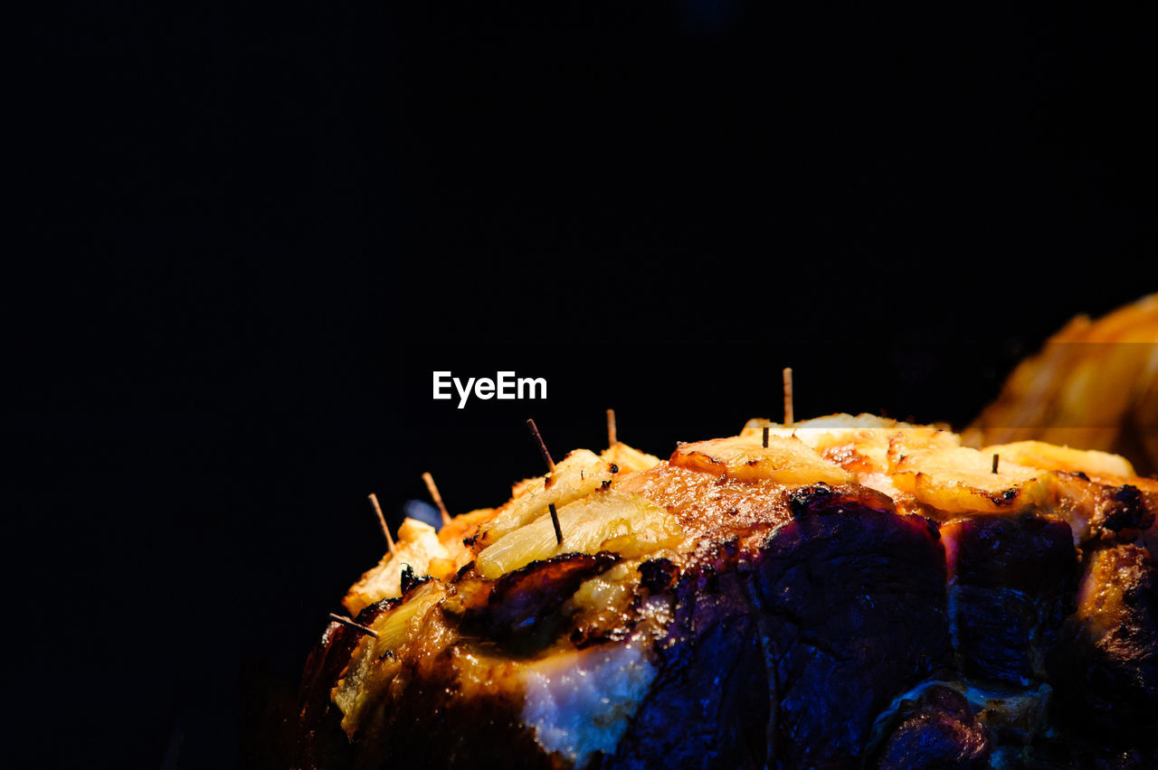 CLOSE-UP OF CAKE ON BLACK BACKGROUND