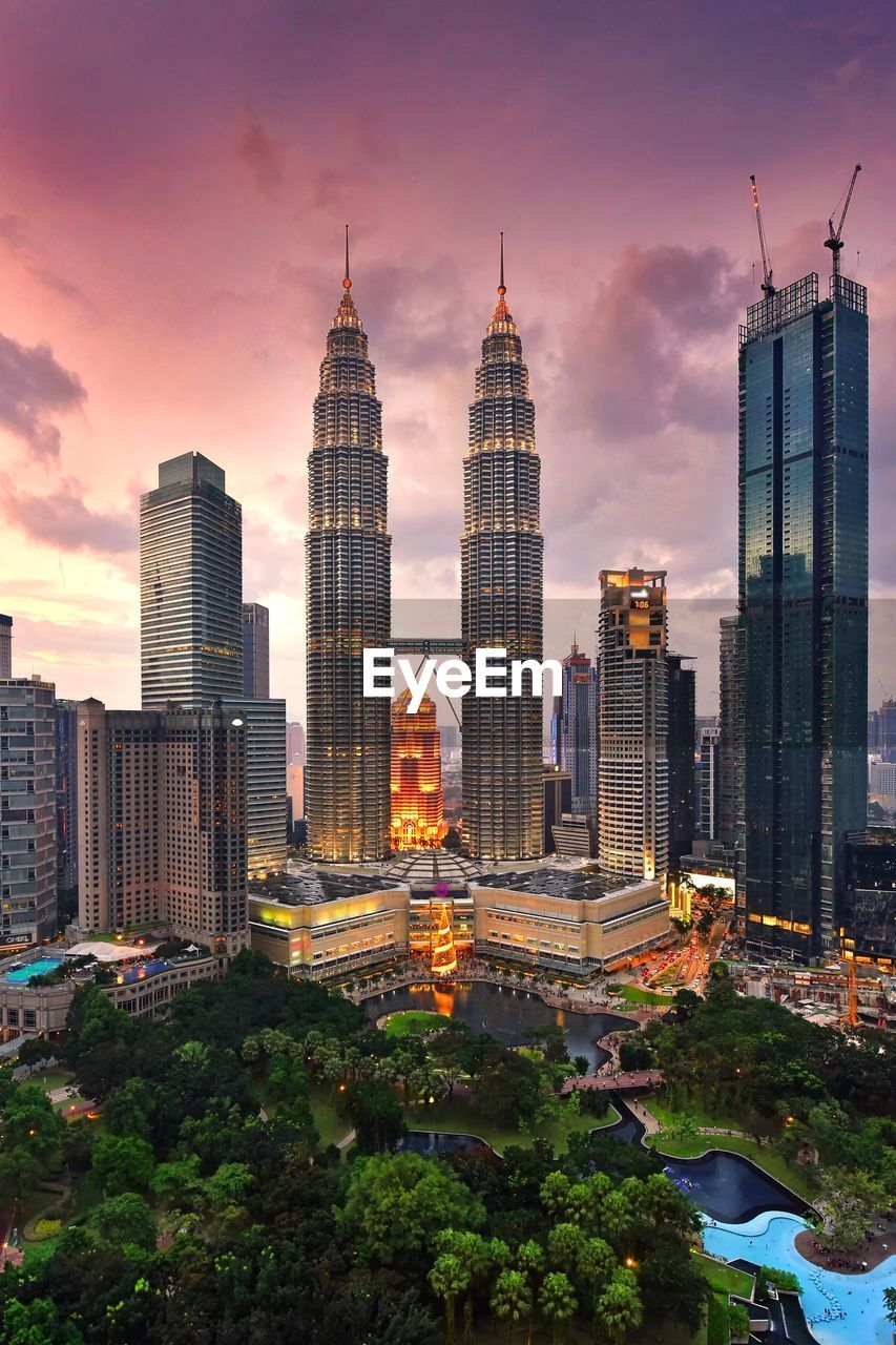 Petronas towers against sky during sunset