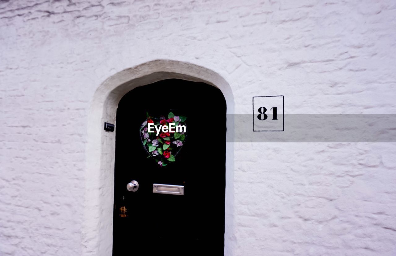 OPEN DOOR OF WHITE BUILDING