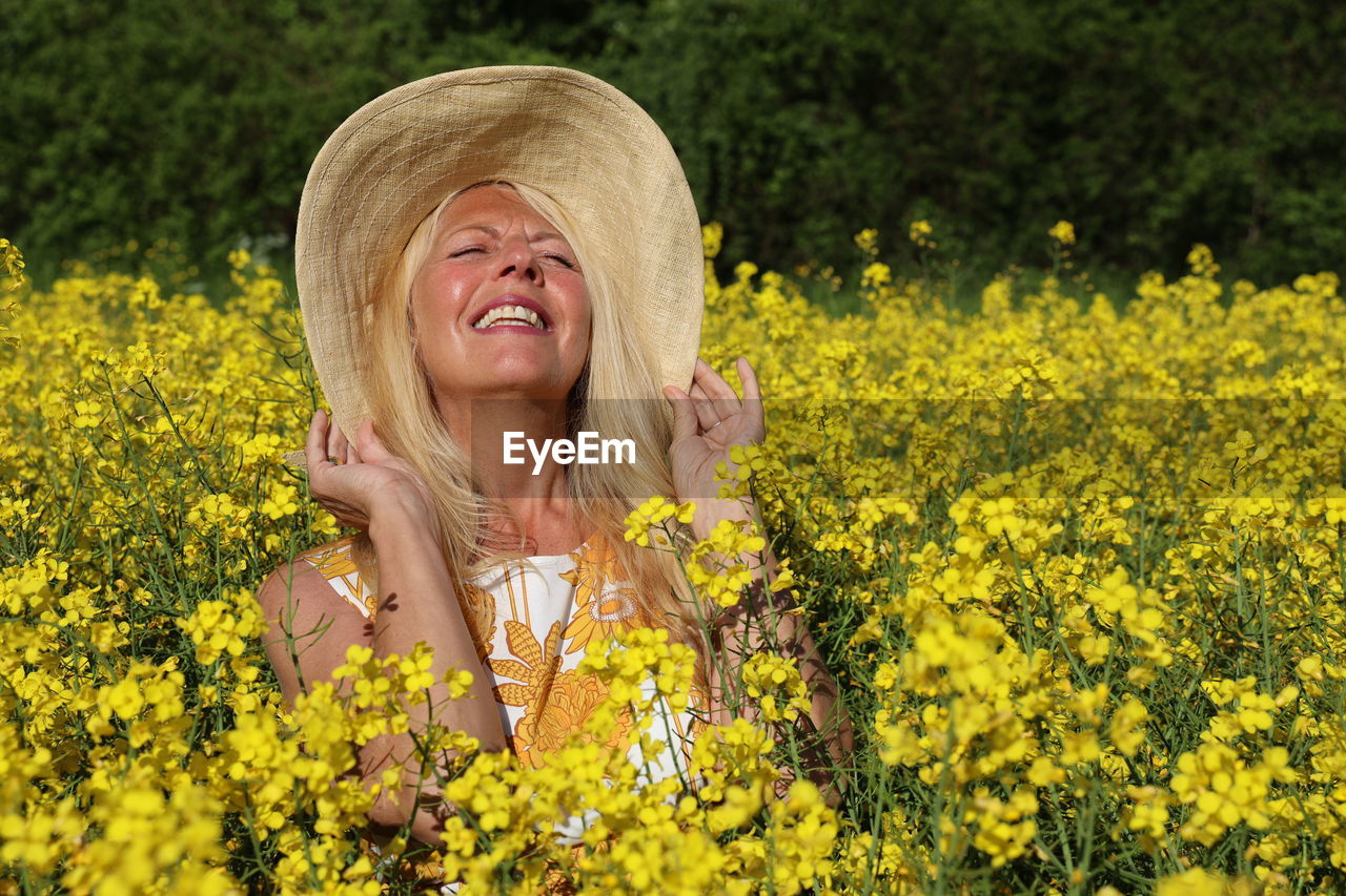 Portrait of a smiling young woman in field