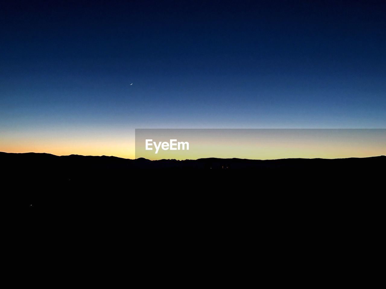 SCENIC VIEW OF SILHOUETTE MOUNTAINS AGAINST SKY DURING SUNSET