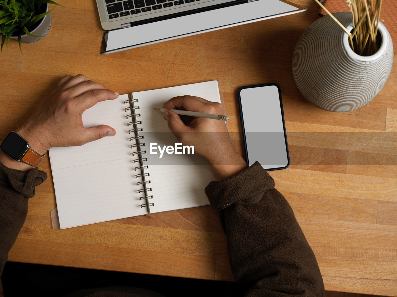 High angle view of man using mobile phone on table