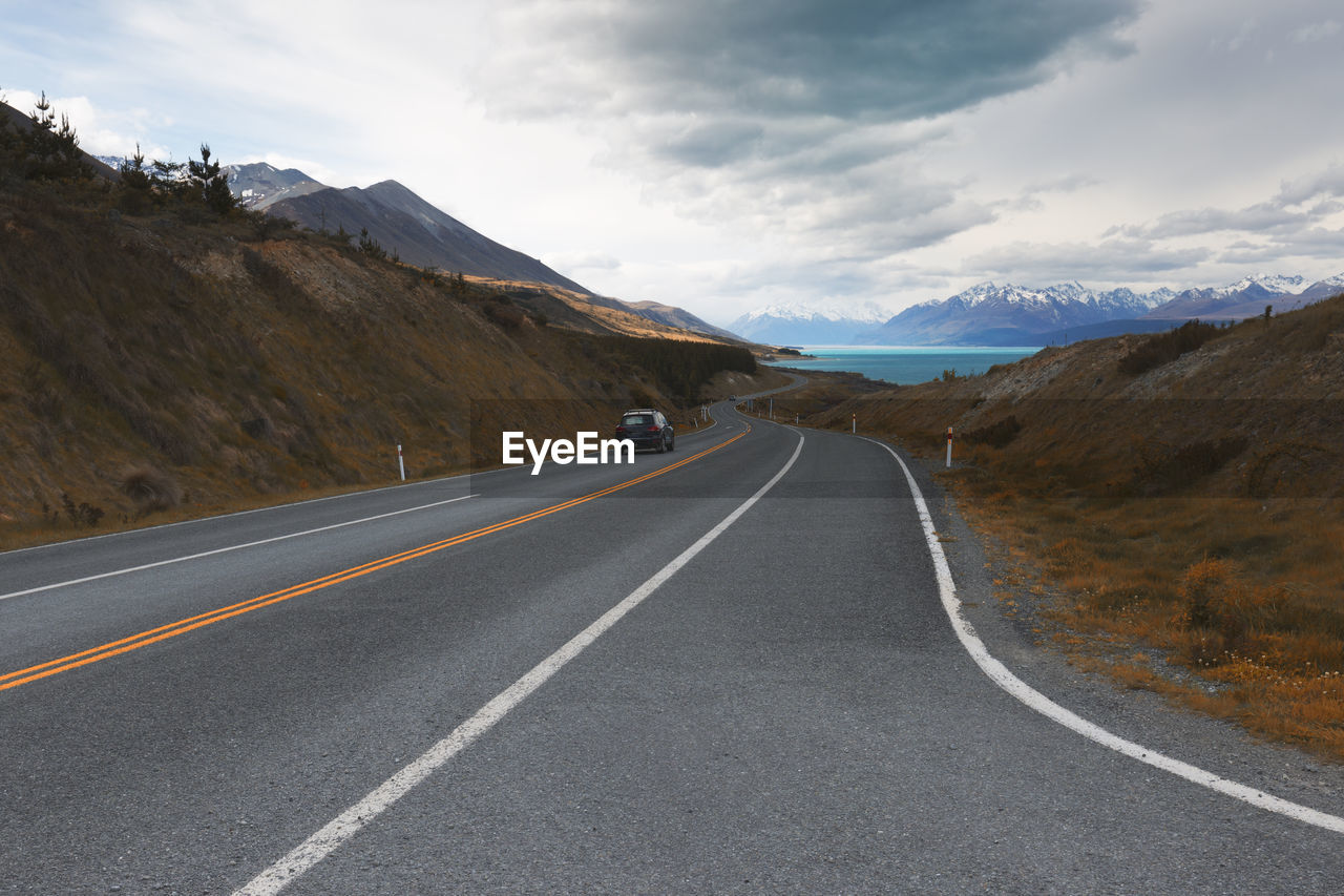 Road amidst mountains against sky