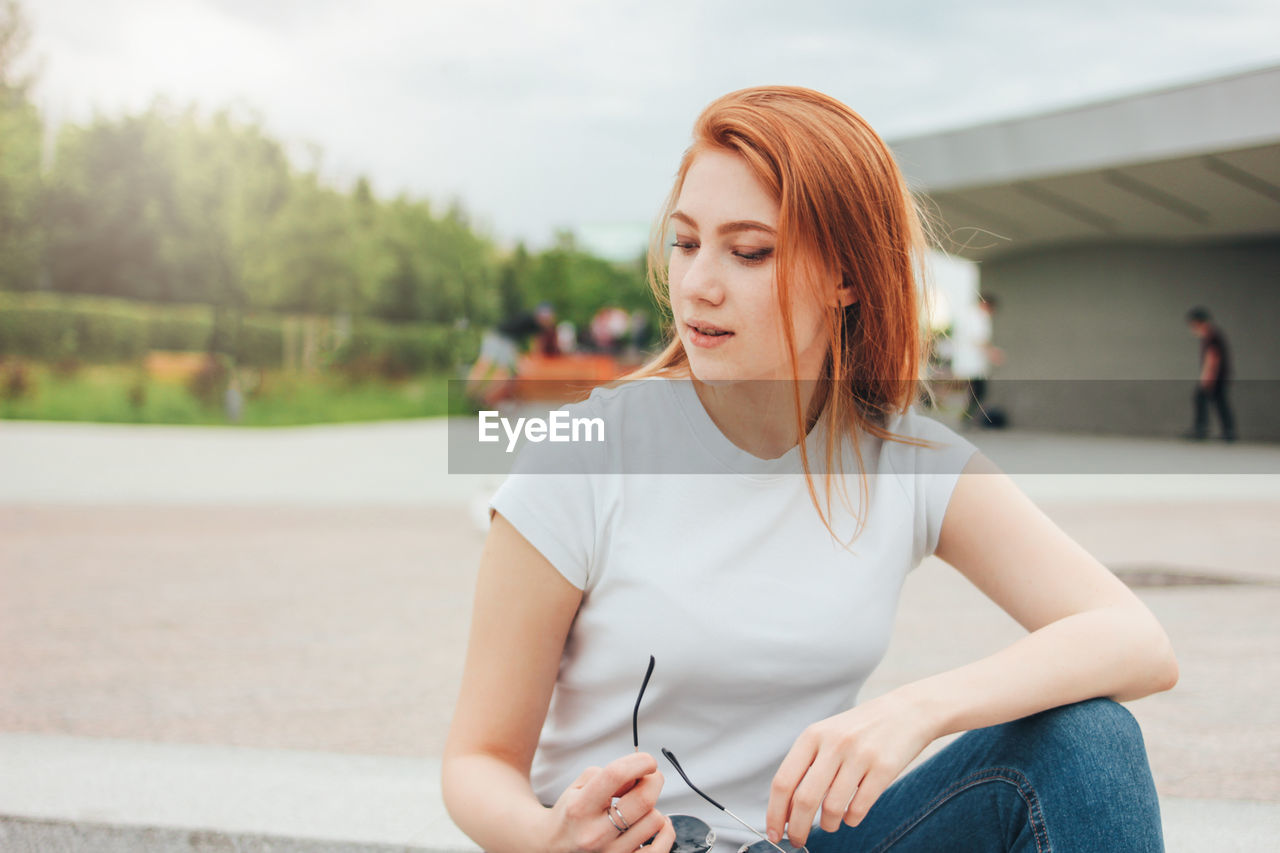 Young woman sitting outdoors