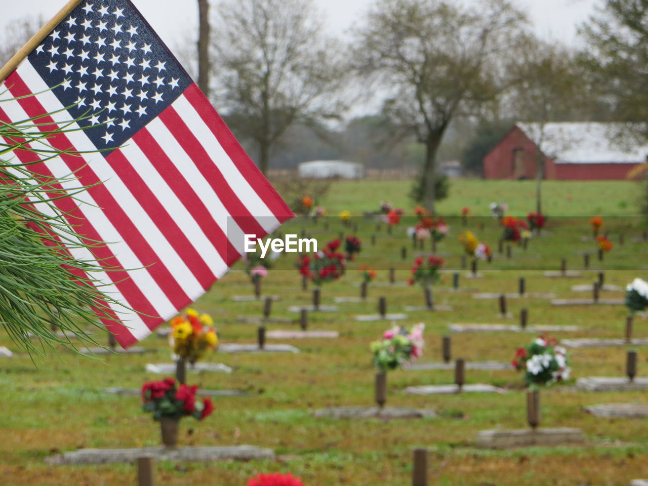 American flag and vases at cemetery