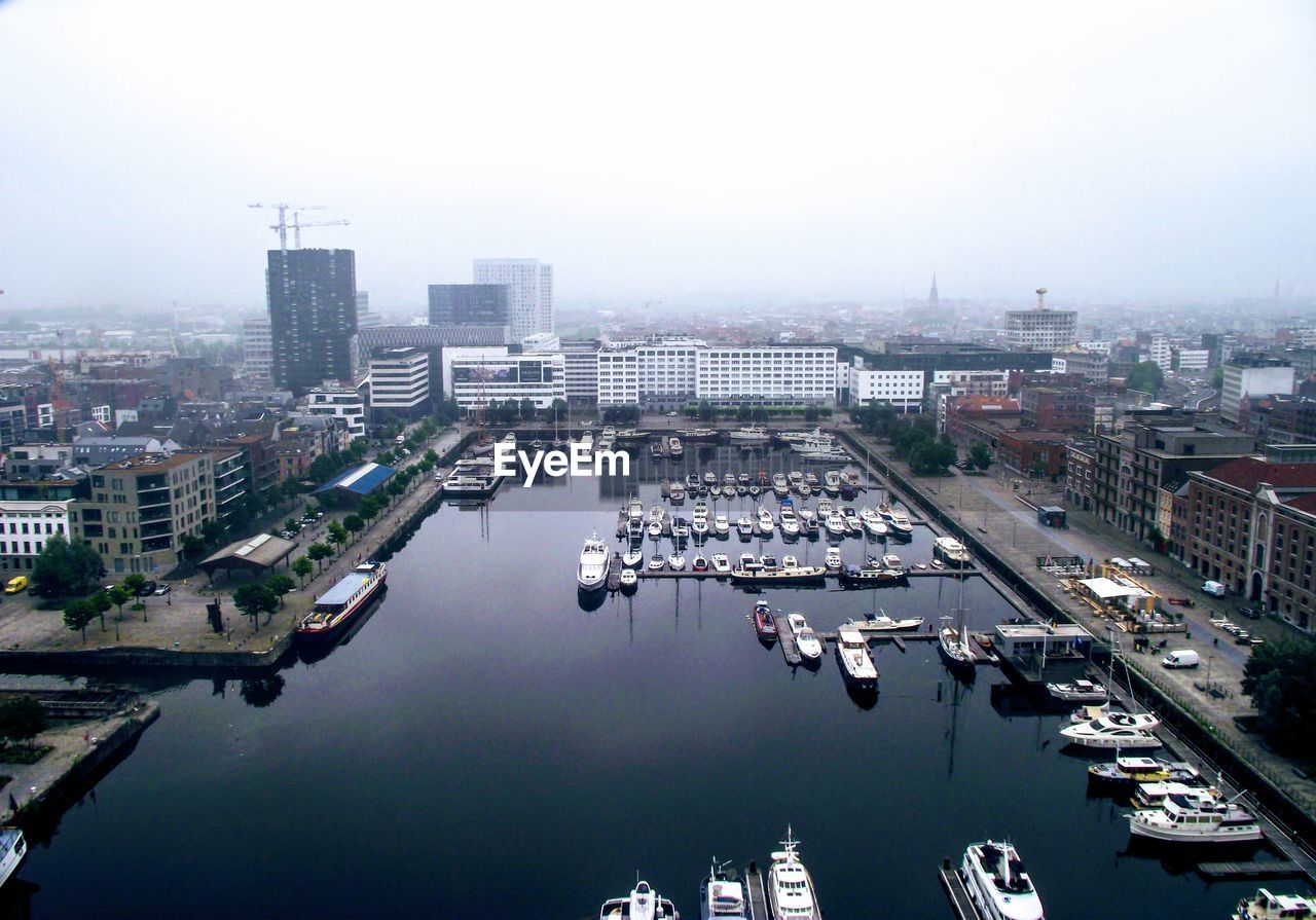 High angle view of city buildings against clear sky