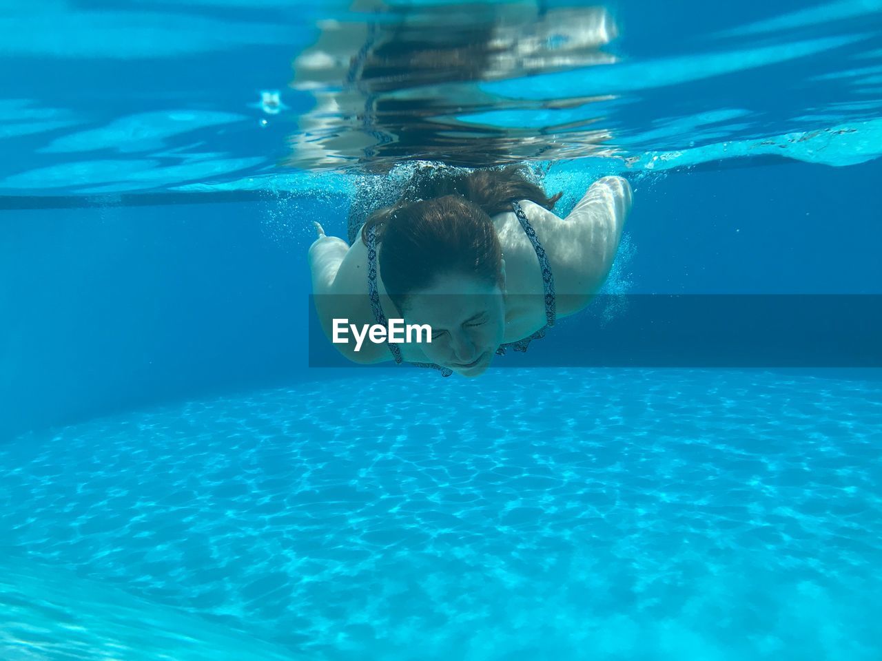 Young woman swimming in pool