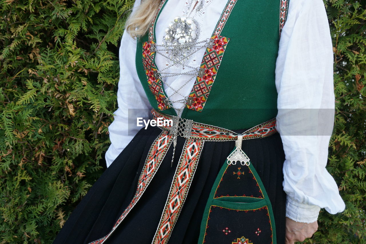 Midsection of woman wearing traditional clothing 