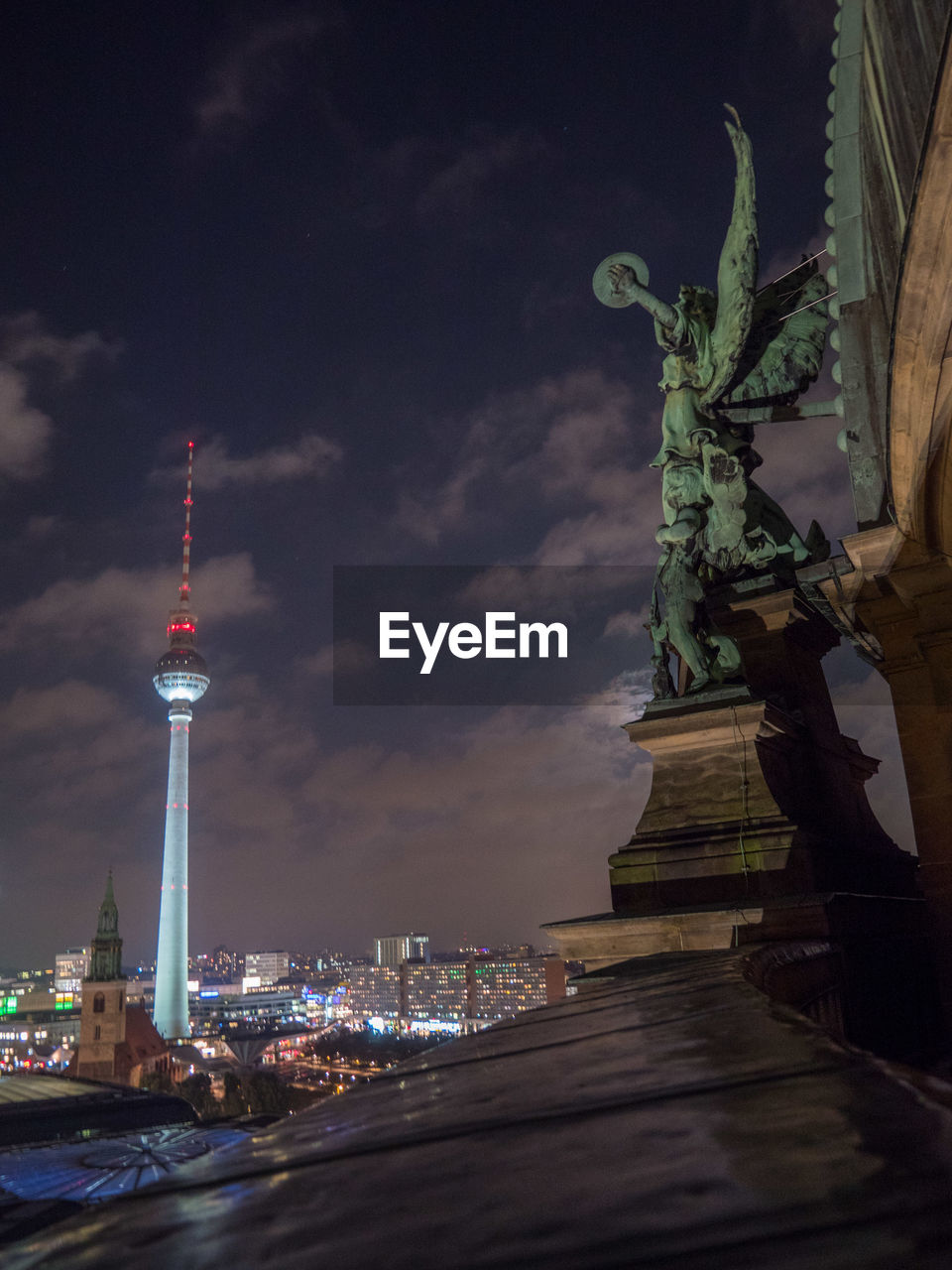 ILLUMINATED TOWER IN CITY AGAINST SKY