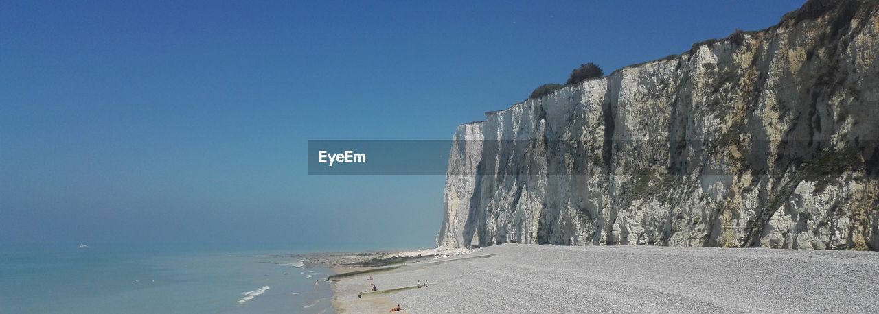 Panoramic shot of sea against clear blue sky