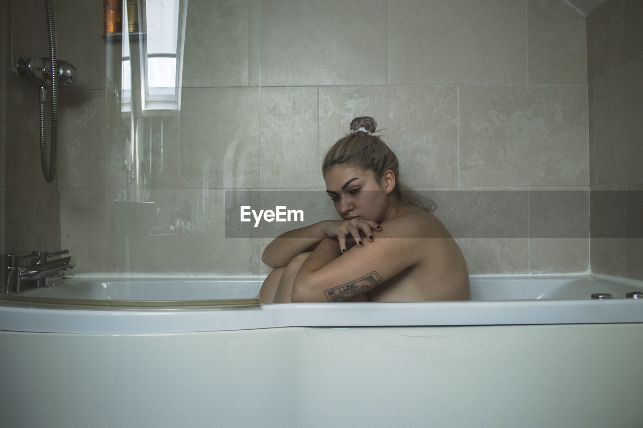 Portrait of young woman in bathroom