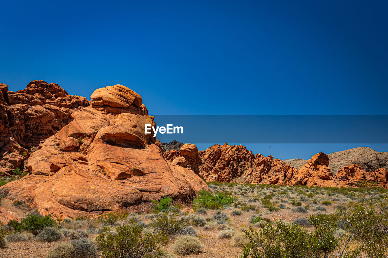 ROCK FORMATIONS AGAINST BLUE SKY