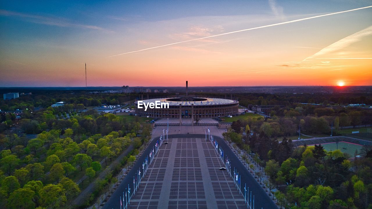 HIGH ANGLE VIEW OF BUILDINGS IN CITY AT SUNSET