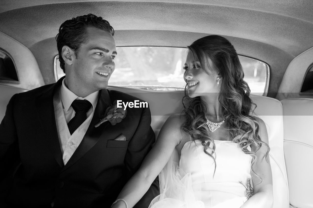 YOUNG COUPLE SITTING IN CAR