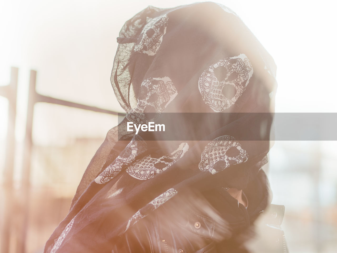 Close-up of woman face covered with scarf outdoors