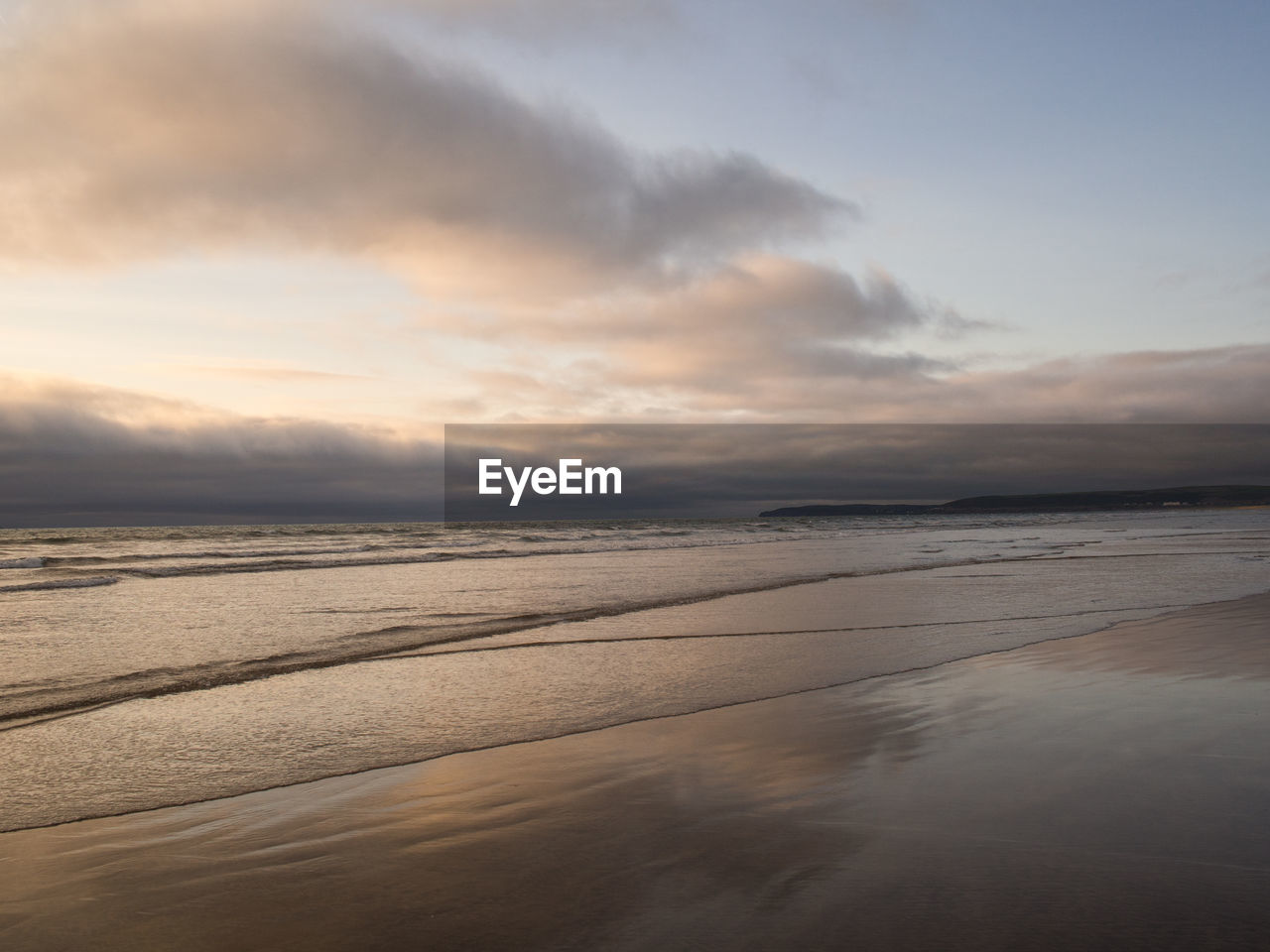 Scenic view of beach against sky during sunset