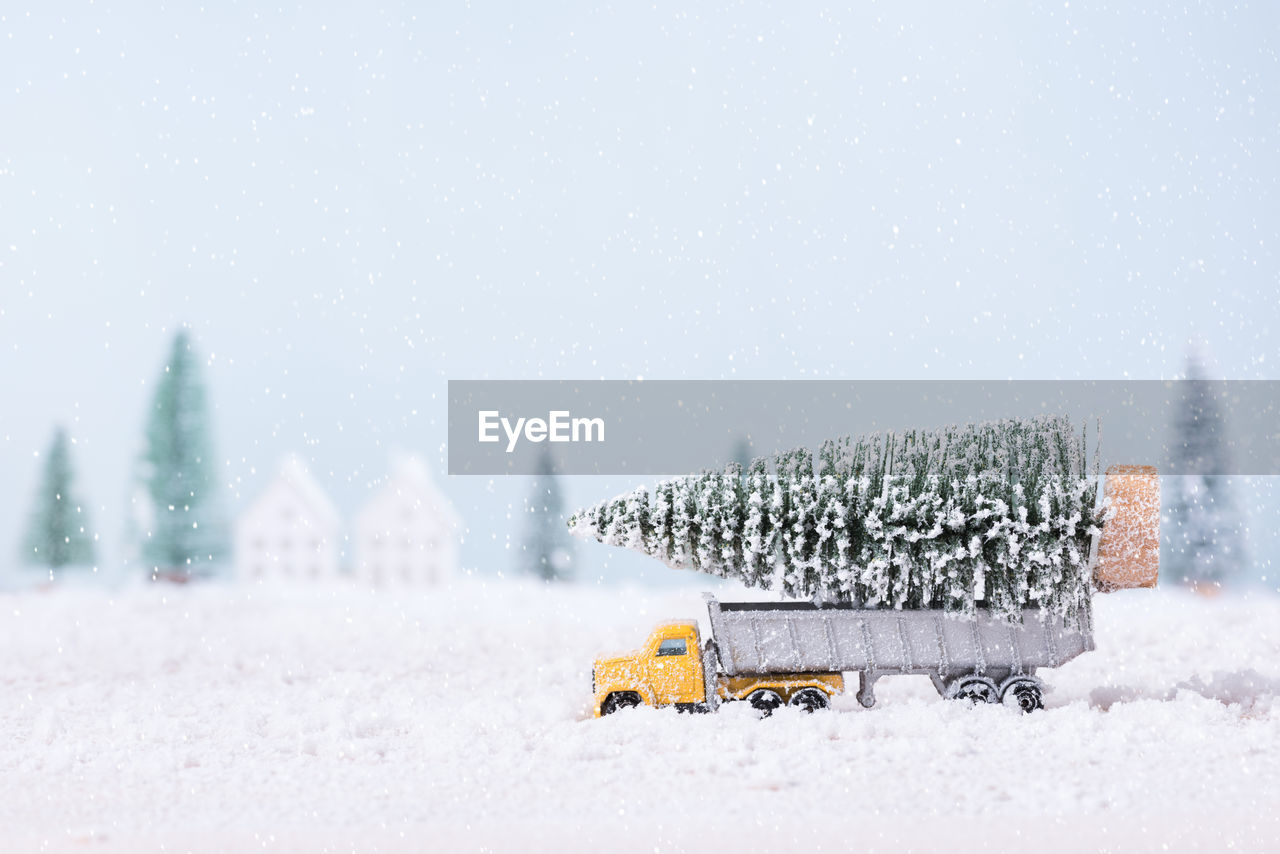 SNOW COVERED CARS ON SNOWCAPPED MOUNTAINS