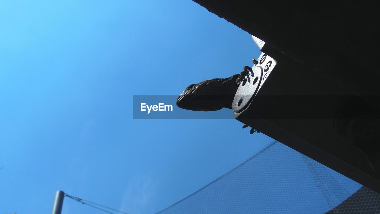 LOW ANGLE VIEW OF BUILT STRUCTURES AGAINST BLUE SKY