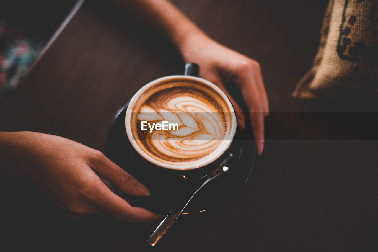 Close-up of woman holding coffee