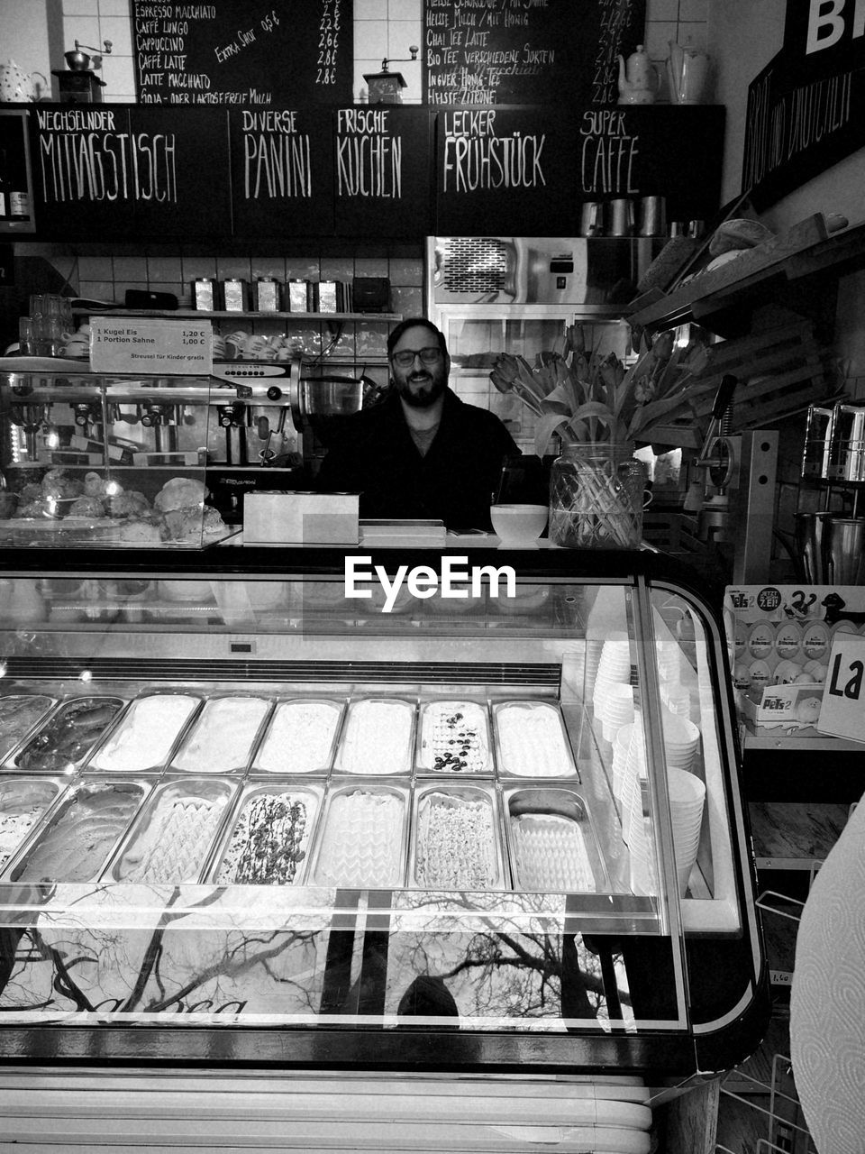 FULL LENGTH PORTRAIT OF A MAN WITH STORE