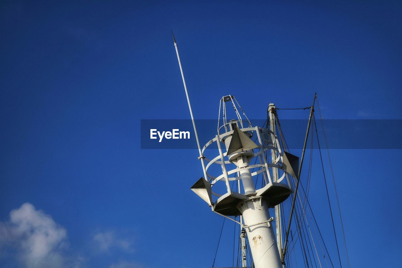 Low angle view of sailboat against blue sky