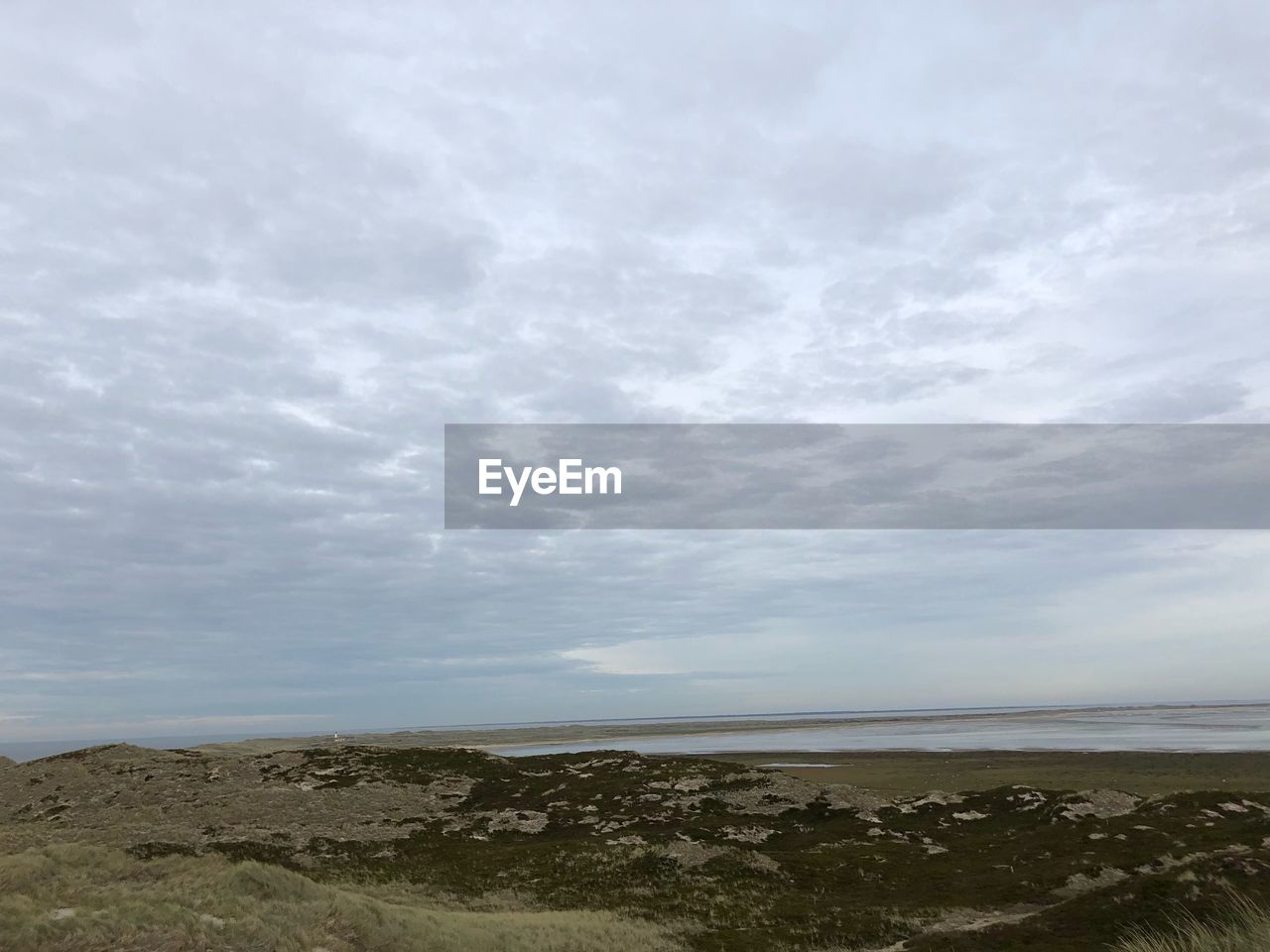 SCENIC VIEW OF SEA SHORE AGAINST SKY