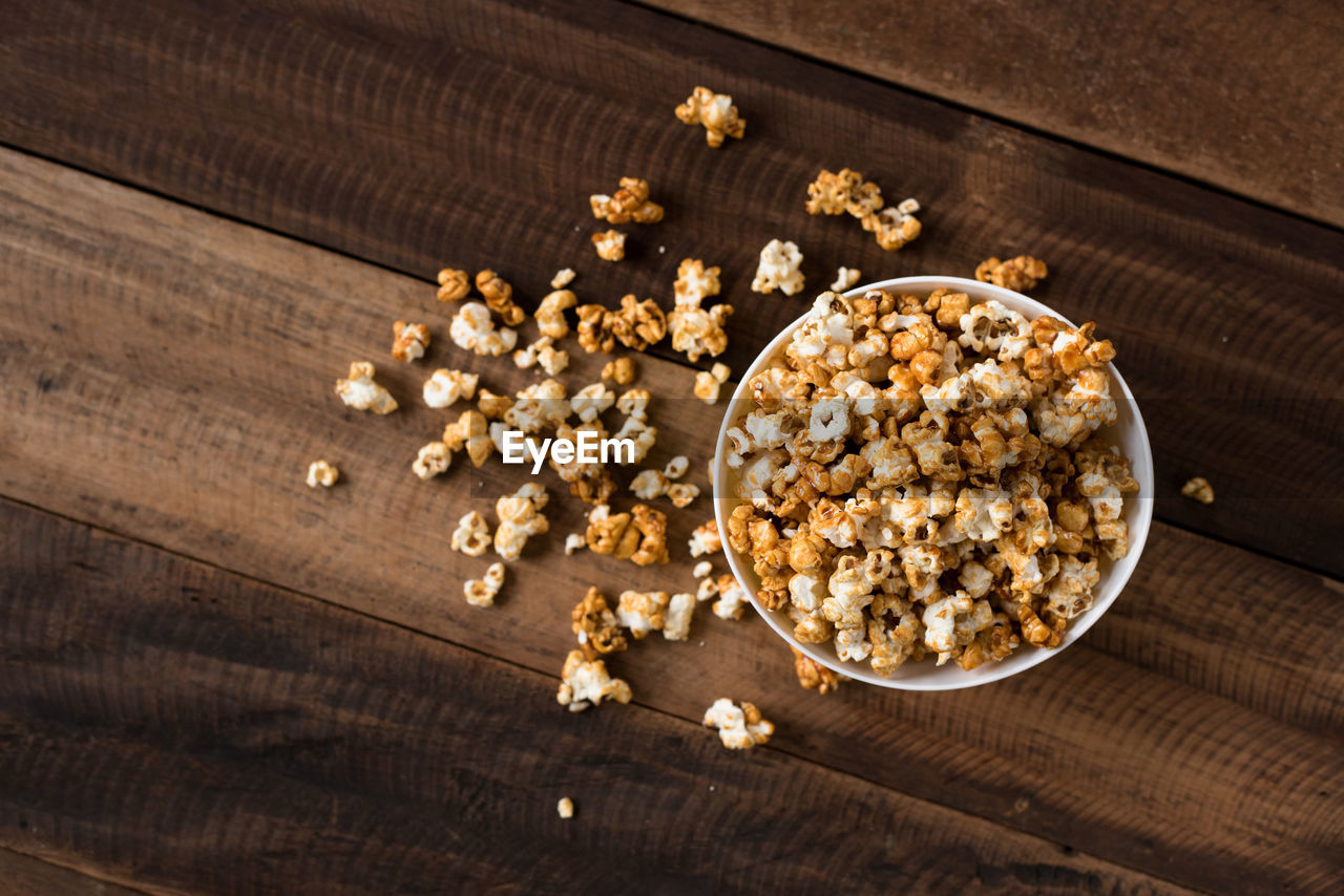 Directly above shot of popcorns in bowl on wooden table