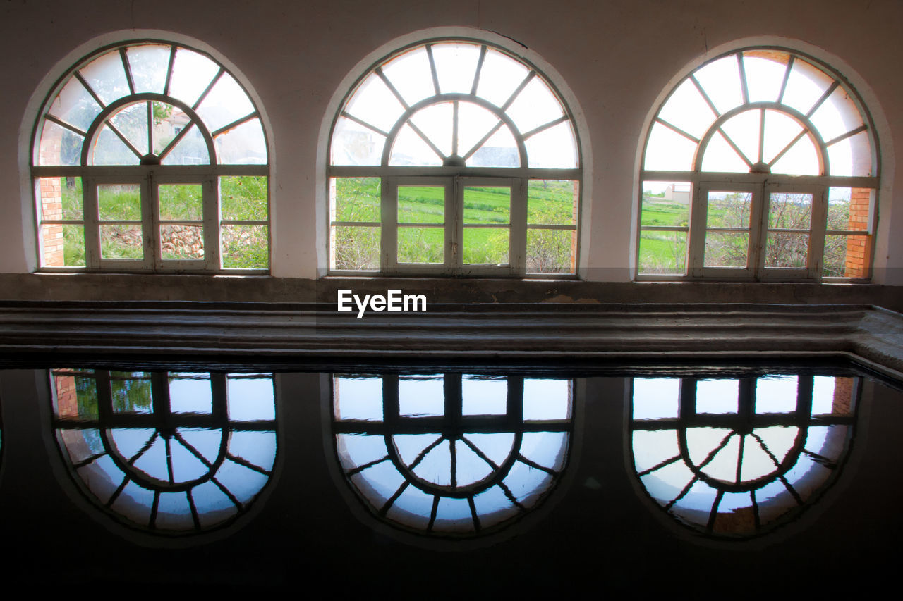 Reflection of arch windows on pond