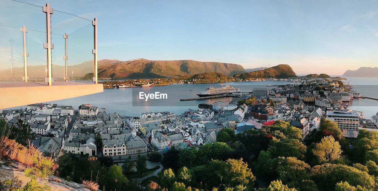 High angle view of city by sea against sky