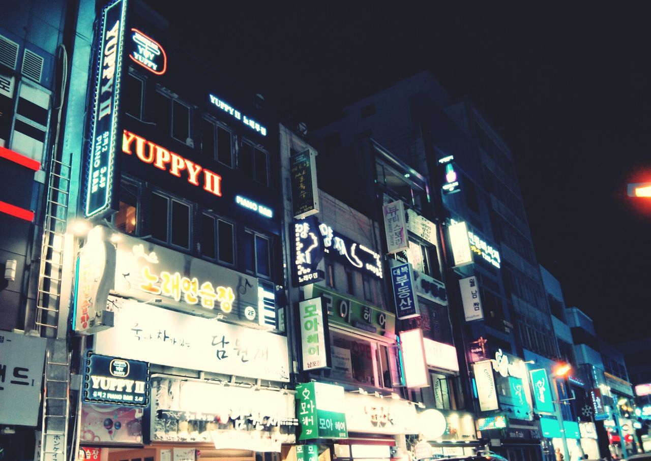 LOW ANGLE VIEW OF ILLUMINATED BUILDINGS