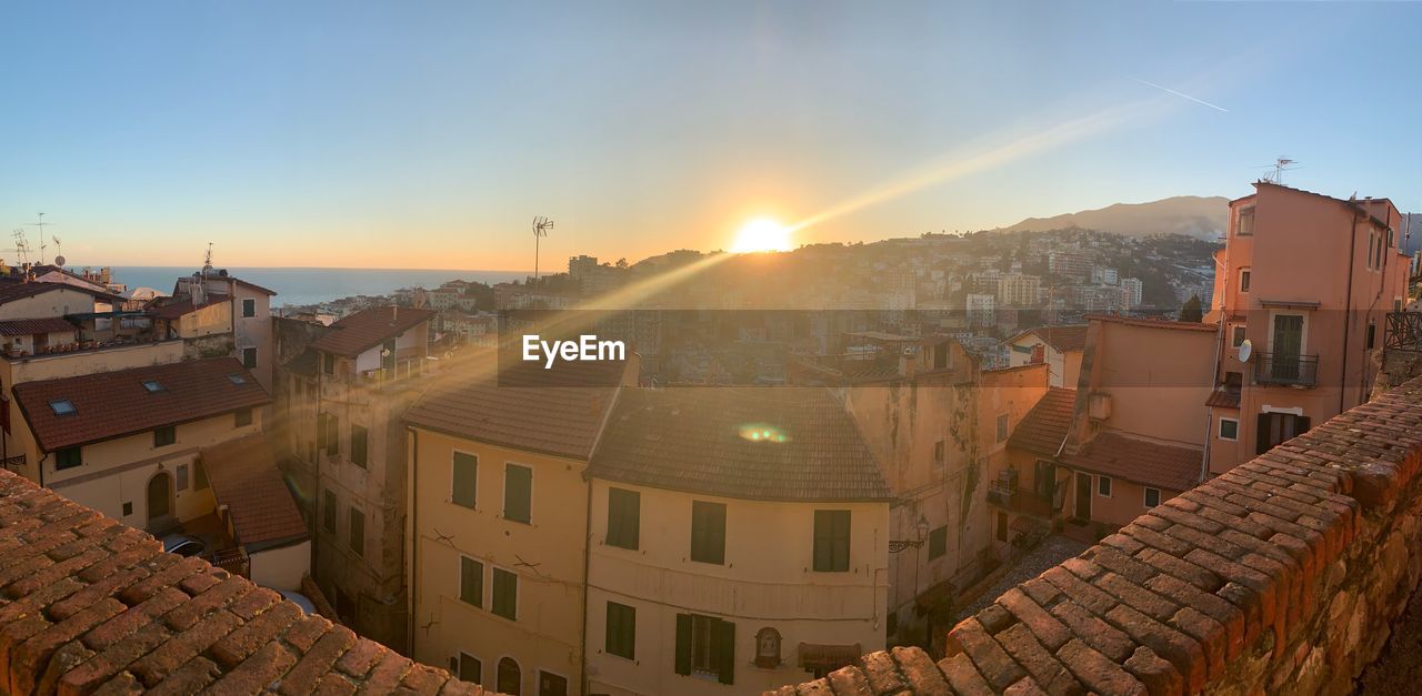 Panoramic shot of townscape against sky during sunset