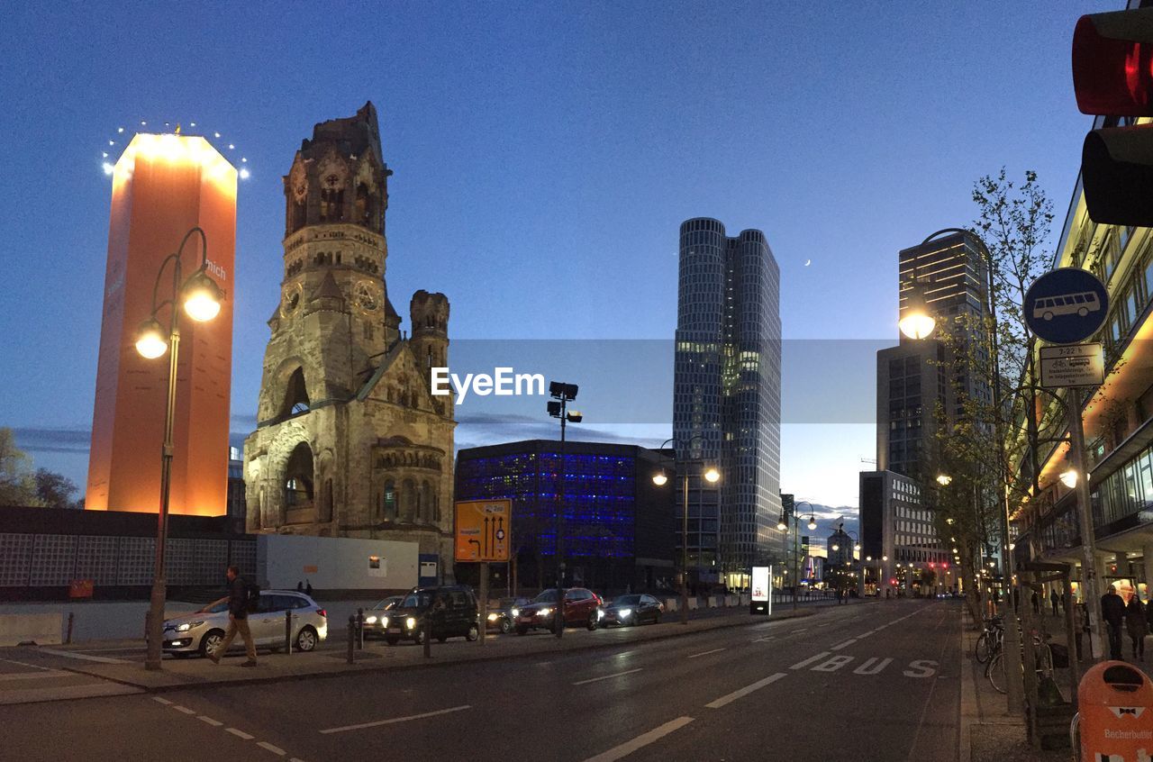 Illuminated city against clear sky at night