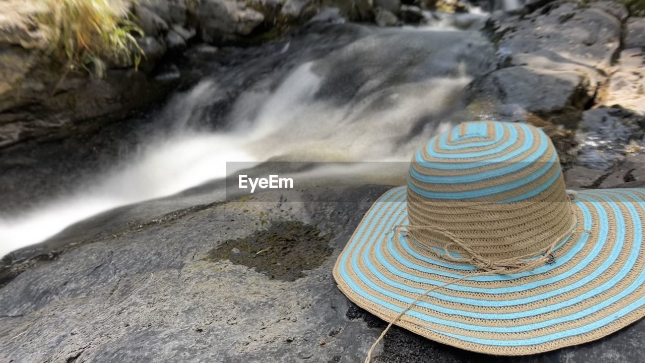 sun hat, hat, water, rock, fashion accessory, water feature, beauty in nature, nature, scenics - nature, land, motion, sombrero, body of water, fedora, outdoors, no people, clothing, high angle view, environment, waterfall, travel destinations, travel, day, long exposure, landscape, tourism