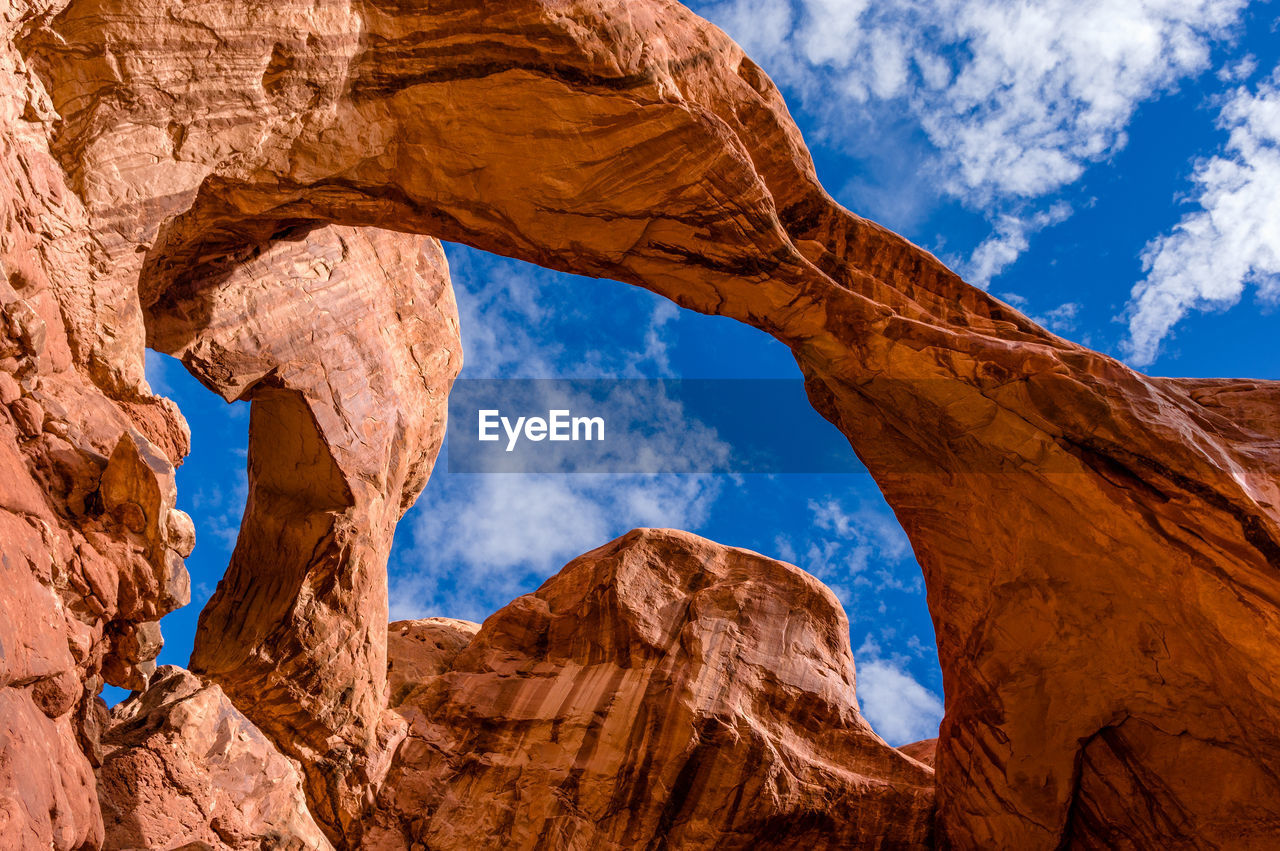 Low angle view of rock formations against blue sky