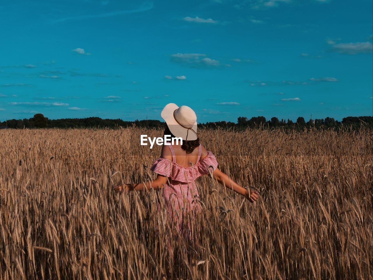 Full length of woman wearing hat on field against sky