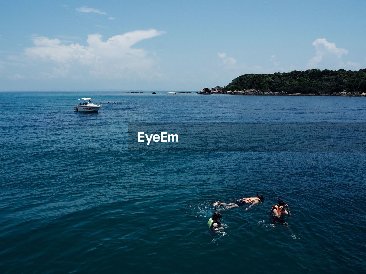 PEOPLE ON SEA AGAINST BLUE SKY