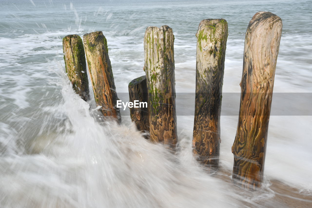 PANORAMIC SHOT OF WOODEN POSTS ON SEA