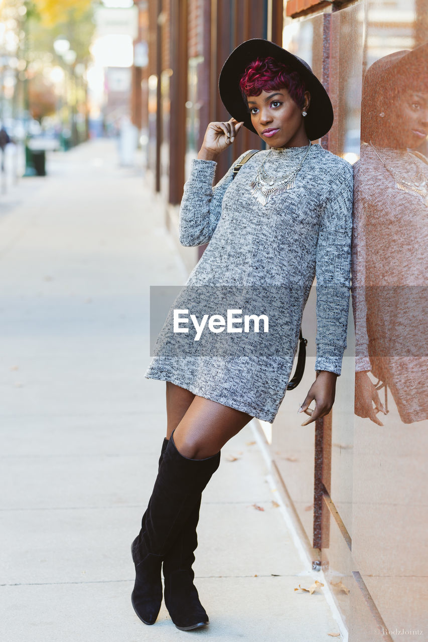 Portrait of woman standing in city