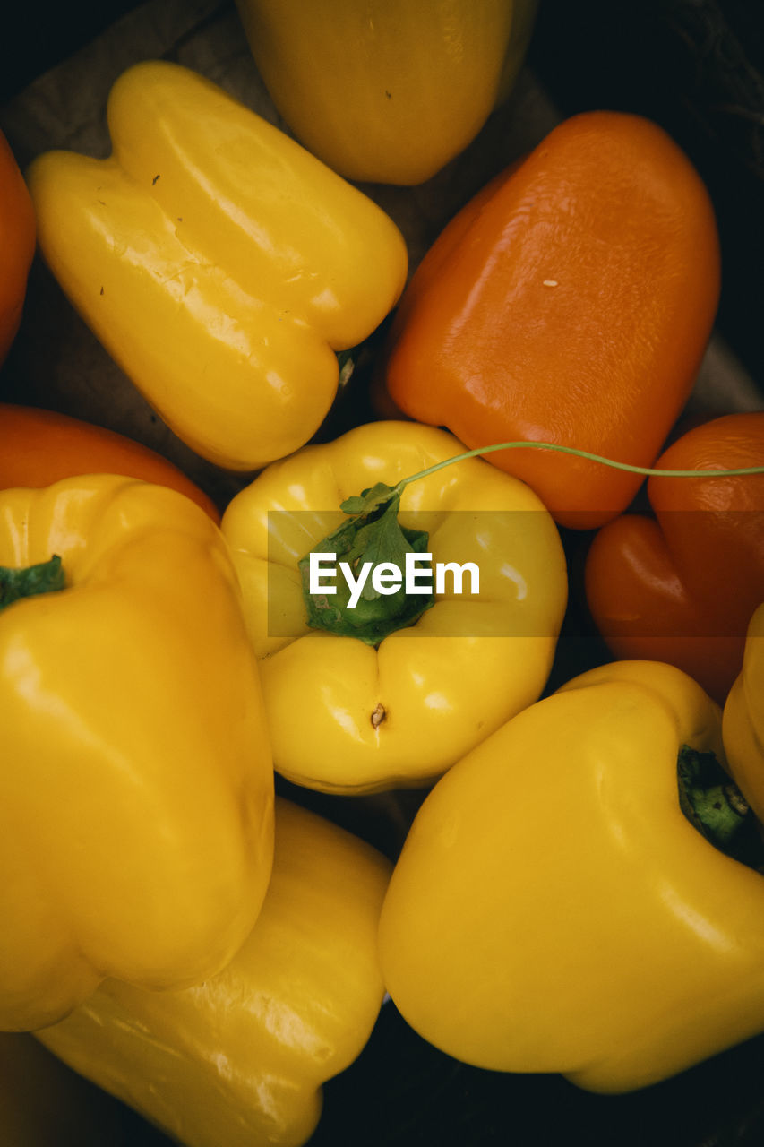 Top down photo of yellow and orange peppers.