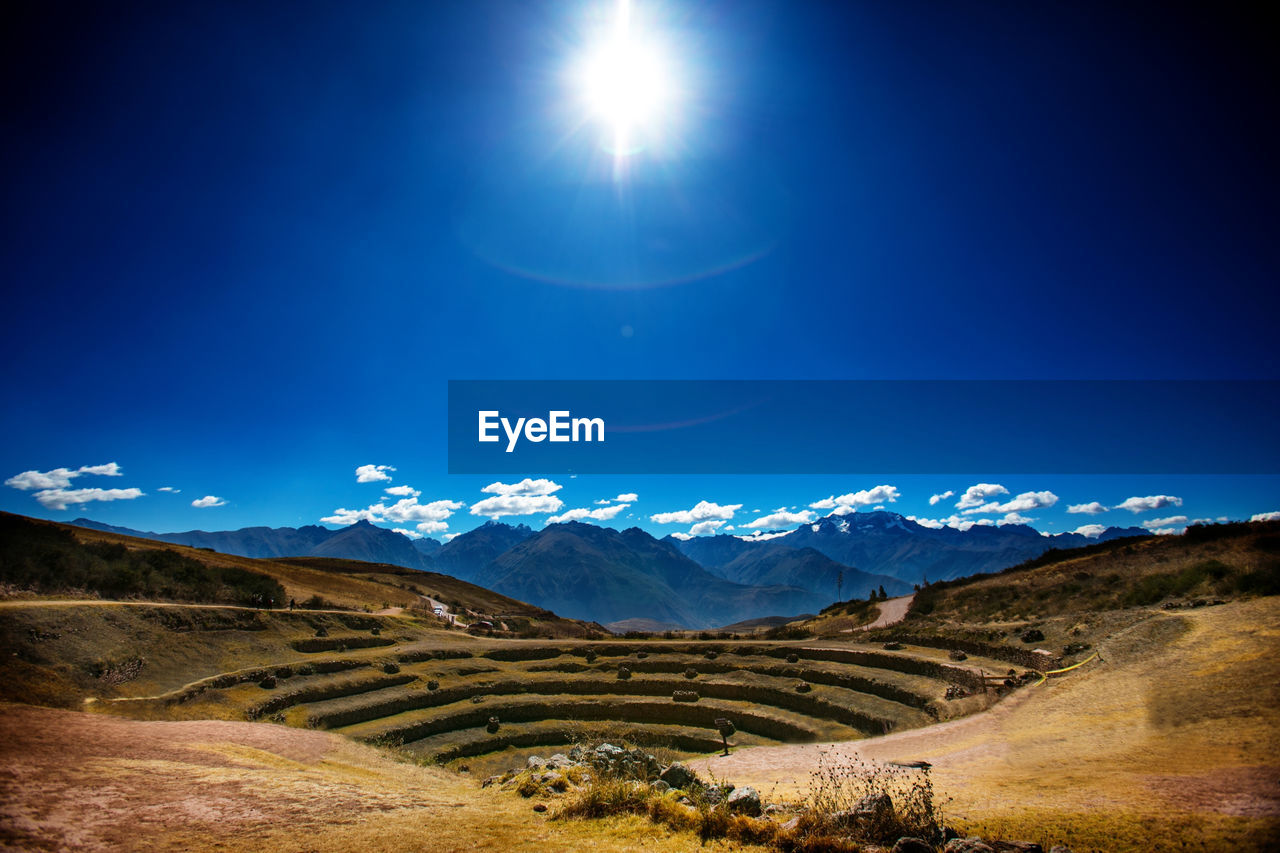 Scenic view of mountains against blue sky